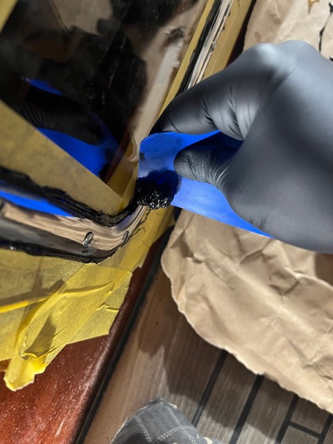 Überschüssiges Pantera wird mit einem blauen Kunststoffspatel abgezogen